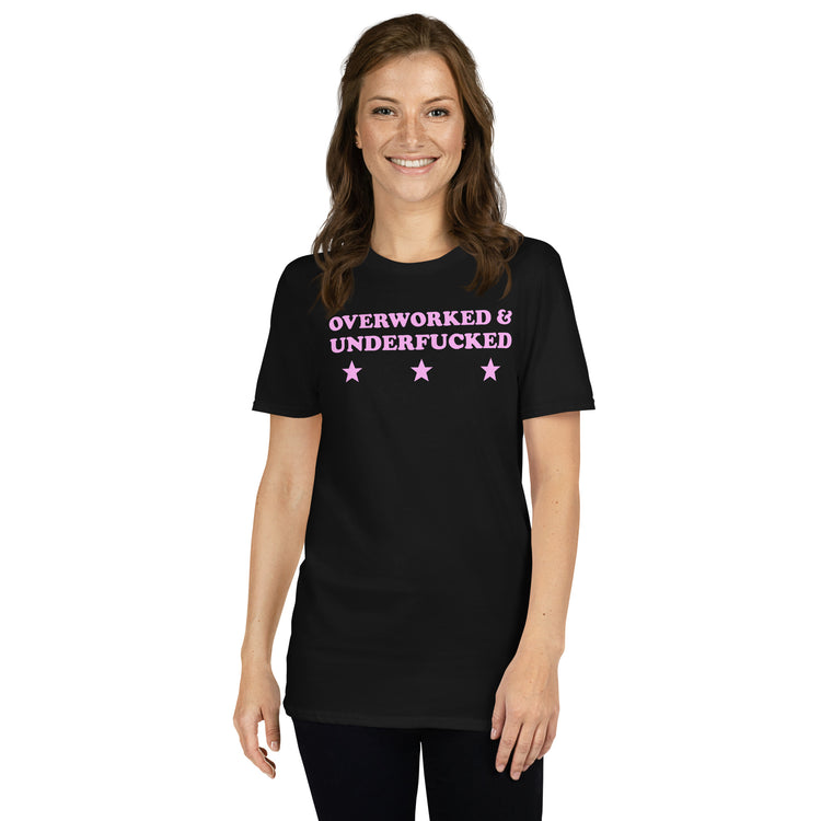 Black unisex t-shirt with "Overworked & Underfucked" graphic print, front view